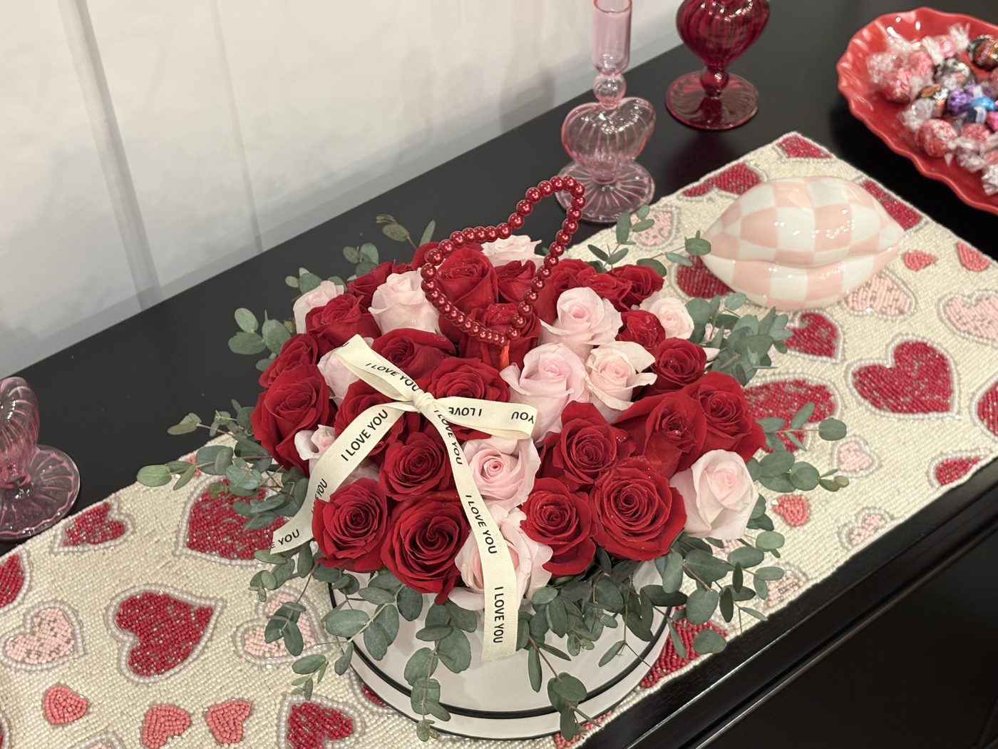 Hatbox of red and pink roses with eucalyptus, a pearl heart and an I Love You ribbon