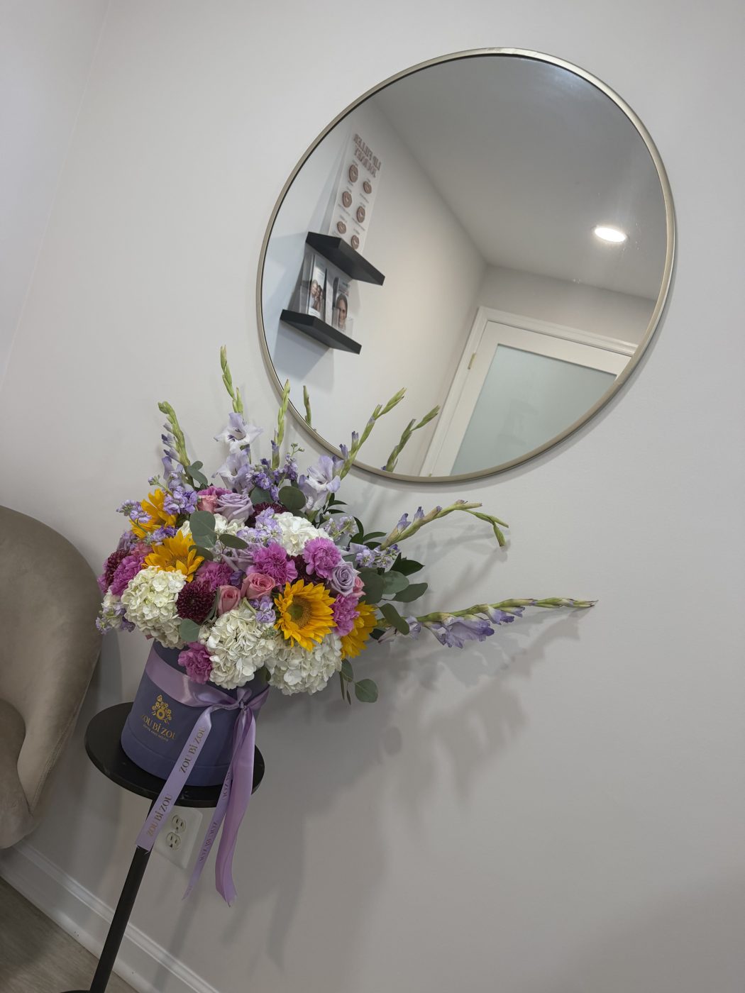 Lavender Zou Bi Zou hatbox of sunflowers, hydrangea, pink carnations, purple roses and lavender gladiolus