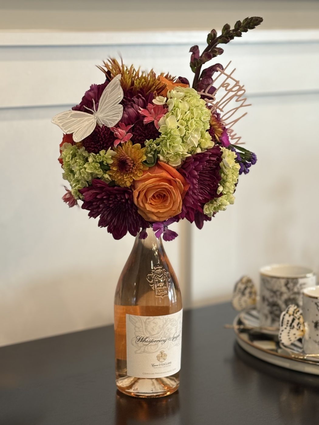 Autumn bouquet arranged on a bottle of rosé